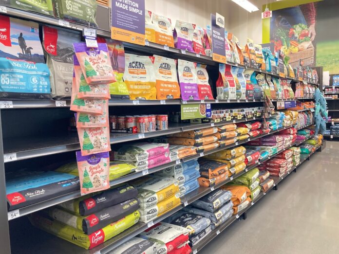 An array of dry dog food displayed in the aisle of a local pet store.