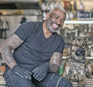 A black male mechanic in his auto repair shop