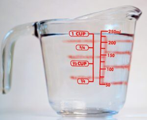 One cup of clear water against a white background