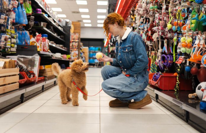 Redhead in a pet shop store Dog essentials are the gear and products that make your dog's training and life easier and more complete.