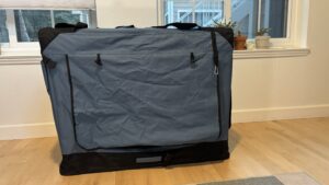 Collapsible dog crates can include door and window covers for seclusion.